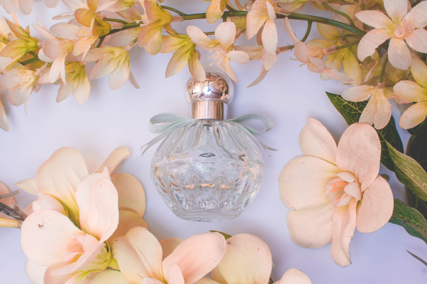 Clear perfume bottle with white flowers